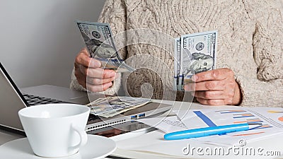 Cash bills from USA currency. Dollars. Senior person handling bills on desk Stock Photo