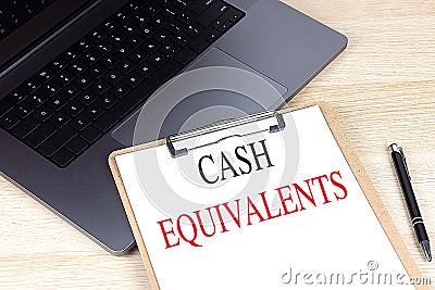 CASH EQUIVALENTS text on clipboard on laptop Stock Photo