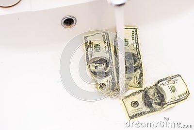 Cash Money Going Down Sink Drain Isolated on White Background Stock Photo