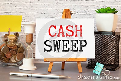 Cash sweep lettering on craft paper, money in the background. Stock Photo