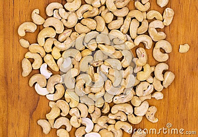 Cashew nuts on wooden background, top view photo. Tasty healthy snack. Scattered nut on table Stock Photo