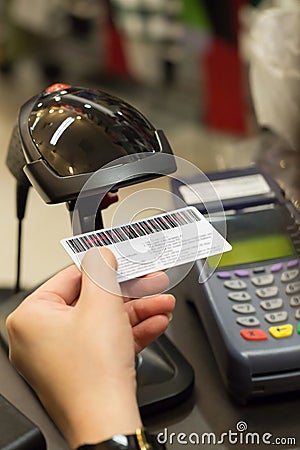 Cashier's hand scanning barcode on member card with credit card Stock Photo