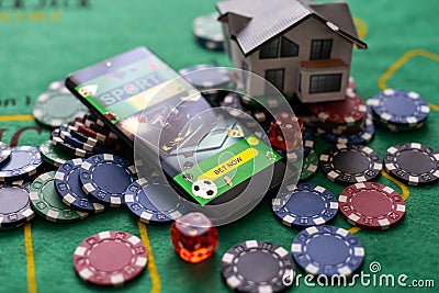 Casino chips with toy house - housing market gamble concept. Stock Photo