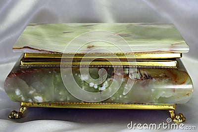 Casket from onyx in a gold frame Stock Photo