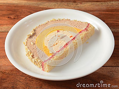 Cassata ice cream served in a white plate over a rustic wooden table, selective focus Stock Photo