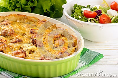 Casserole with potatoes, sausages, tomatoes and cheese. Stock Photo