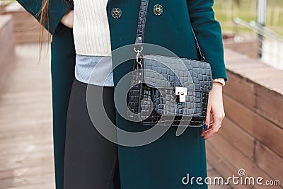 Cassic coat with handbag Stylish fashion model outdoor. Stock Photo