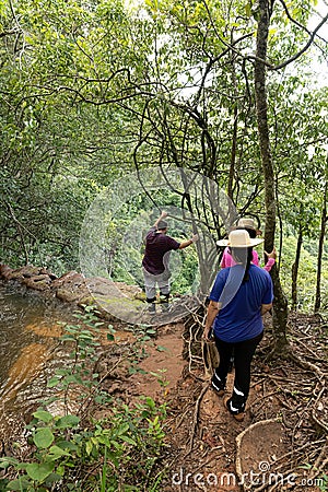 Cassilandia, Mato Grosso do Sul, Brazil - 02 28 2023: People trekking to a waterfall Editorial Stock Photo