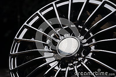 Cast aluminum disc alloy wheel modern, close-up on black background, spokes and rim Stock Photo