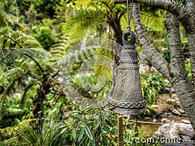 A cast-iron bell in the garden Stock Photo