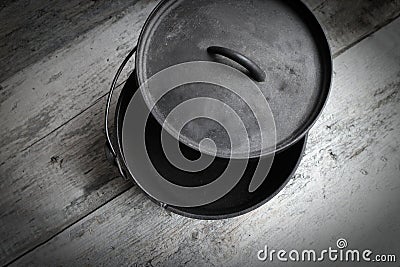 Cast Iron Dutch Oven Half Open On Wooden Background Stock Photo