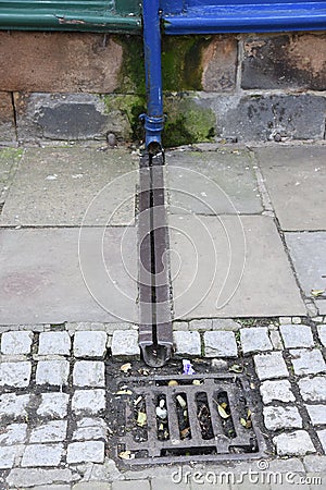 Cast iron rain stormwater drainage system a pipe and slit tray Stock Photo