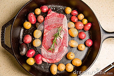 Cast iron skillet salt and pepper raw organic steak meat Stock Photo