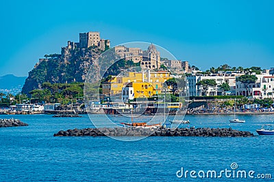 Castello Aragonese behind hotels of Italian island Ischia Editorial Stock Photo