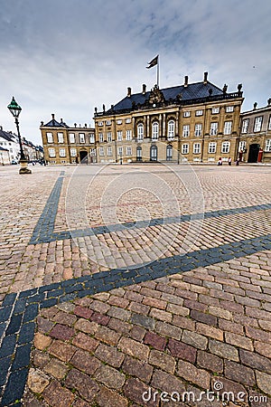 Castle Amalienborg with statue of Frederick V in Copenhagen, Denmark. The castle is the winter home of the Danish royal family Editorial Stock Photo