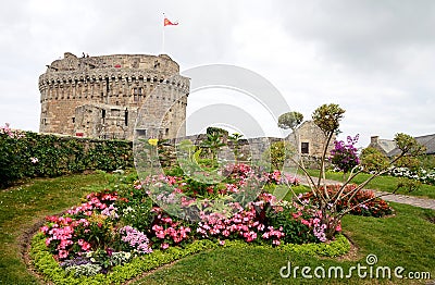 Castle of Dinan with beautiful flowers in forefront, Brittany, France Stock Photo