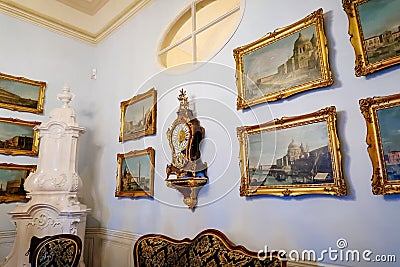 Castle interior. Antique clock and paintings in carved frames on the wall. Renaissance castle Horsovsky Tyn, Czech Republic Editorial Stock Photo