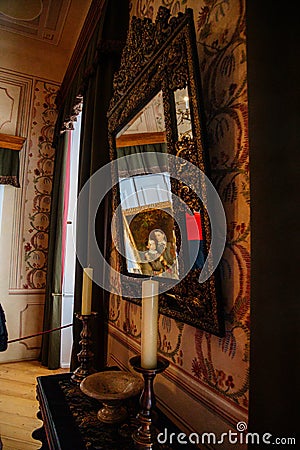 Castle interior. Antique mirror in a carved frame. Castle Duchcov, Czech Republic Editorial Stock Photo