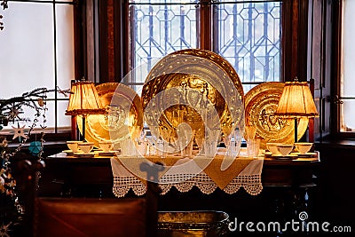 Castle interior, Large gold ceremonial dishes, crystal glasses, Christmas decorations, Historic Medieval Romantic castle Hradek u Editorial Stock Photo