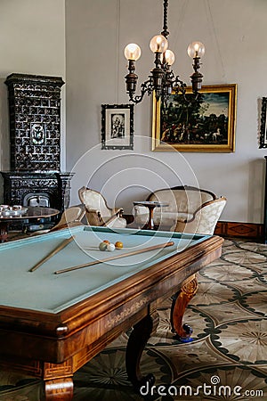 Castle interior. Men`s salon with ceramic stove and billiard table. Castle Kacina, Empire Chateau near Kutna Hora, Bohemia, Czech Editorial Stock Photo