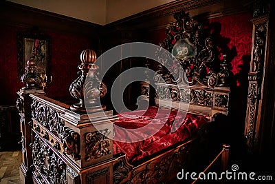 Castle interior, Retro style bedroom with baroque and renaissance furniture, red velvet, Castle Bouzov, Moravia, Czech Republic Editorial Stock Photo