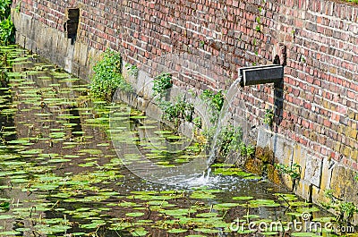 Castle moat with rainwater inlet Stock Photo