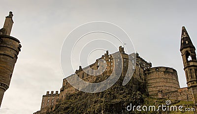 Castle Rock and Edinburgh Castle, seen from below and framed by a chimney and spire Stock Photo