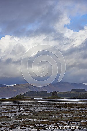 Castle Stalker under dramatic skies on one of the small Islands that dot the coastline of Loch Linnhe. Stock Photo