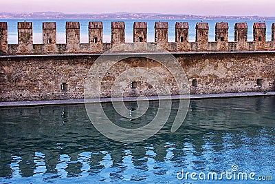 Castle Wall in Water in Italy Stock Photo