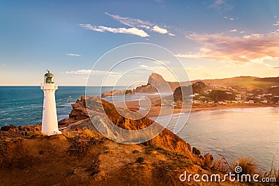 Castlepoint Lighthouse and the village of Castlepoint with Castle Rock in the distance. Stock Photo