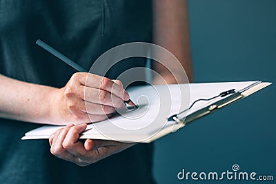 Casual adult female writing notes on notepad paper Stock Photo