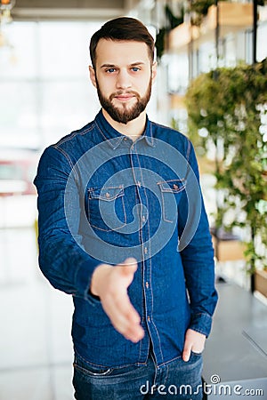 Casual Bearded Man Wear Checked Blue Shirt Hold Hand Shake Greeting Over White Brick Wall Stock Photo