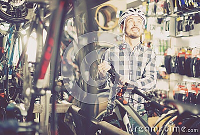 Casual biker cyclist is buying high-speed bike Stock Photo