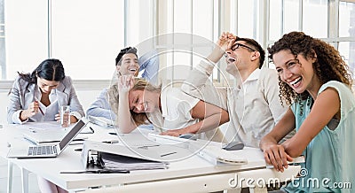 Casual business team laughing during meeting Stock Photo