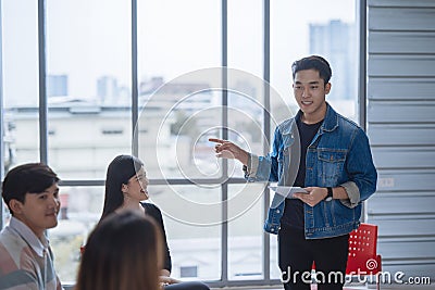 Casual businessman having business meeting with his staff. showing presentation. Stock Photo