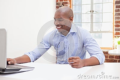 Casual businessman using his laptop at desk Stock Photo