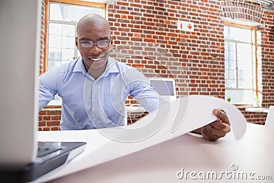 Casual businessman using his laptop at desk Stock Photo