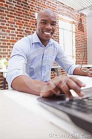 Casual businessman using his laptop at desk Stock Photo