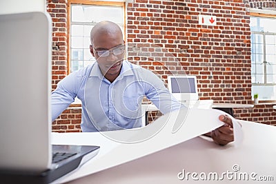 Casual businessman using his laptop at desk Stock Photo