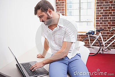 Casual businessman using his laptop at desk Stock Photo