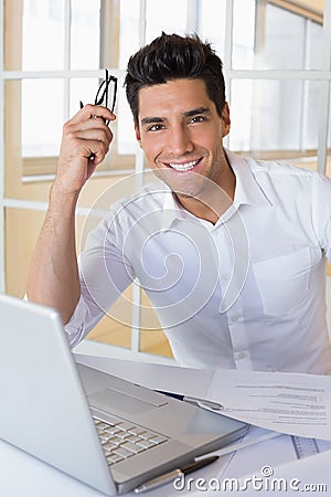 Casual businessman using his laptop at his desk Stock Photo
