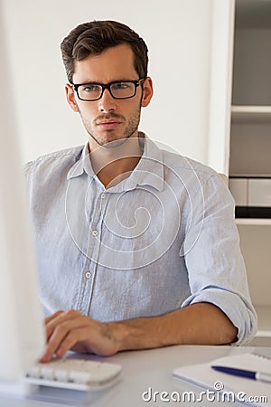 Casual businessman working at his desk Stock Photo