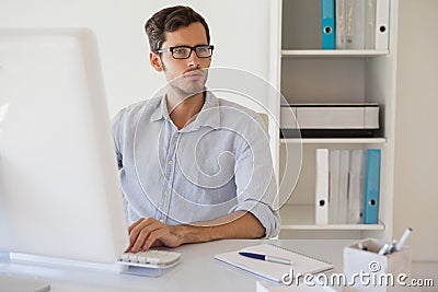 Casual businessman working at his desk Stock Photo