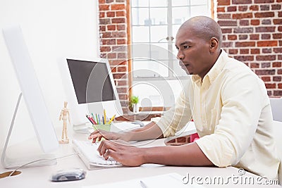 Casual businessman working at his desk Stock Photo