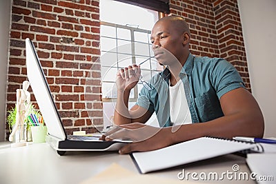 Casual businessman working at his desk Stock Photo