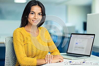 Casual businesswoman sitting at her workplac Stock Photo