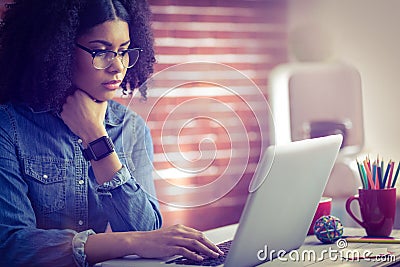 Casual businesswoman using laptop and smartwatch Stock Photo