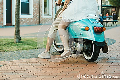 Casual couple riding on scooter outdoors Stock Photo