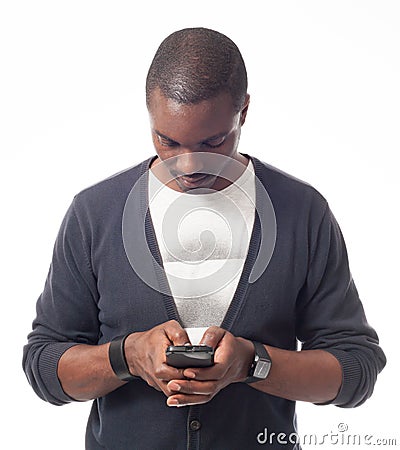 Casual dressed black man looking his mobile phone. Stock Photo