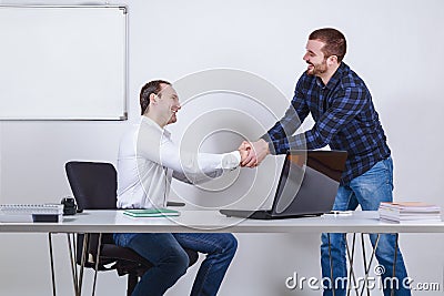 Casual dressed businessmen shaking hands Stock Photo